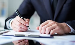 Person writing down on paper