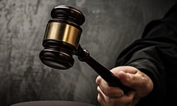 Judge holding gavel in right hand